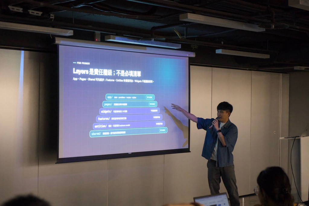 講者指著投影幕說明架構